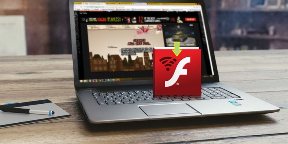 A Laptop That Showing Online Game - A Red Flash Download Icon Placed On It.
